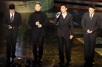 Four stars of Canto-pop songs, from left, Aaron Kwok, Jacky Cheung, Andy Lau, Leon Lai, sing one of Hong Kong pop star and actor Leslie Cheung's songs at the start of the Film Award ceremony at Hong Kong's Cultural Center Sunday, April 6, 2003, in a tribute to Cheung who committed suicide last week. (AP Photo/Vincent Yu)