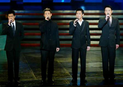 Four Hong Kong top Canto-pop singers (from L-R) Aaron Kwok, Jacky Cheung, Andy Lau and Leon Lai sing as they pay tribute to Canto-pop star Leslie Cheung at the start of the 22nd Hong Kong Film Awards April 6, 2003. The flamboyant 46-year-old actor, singer and director, who was nominated for the Best Actor award for his role in Inner Senses at the annual film awards, jumped to his death on April 1. Cheung was best known internationally for his role in the hit movie 'Farewell My Concubine', where he played a homosexual Chinese opera-singer - a role which closely mirrored his life.    REUTERS/Kin Cheung