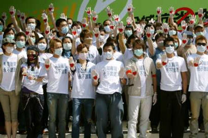 Hong Kong artists including (from left) Gigi Leung, Cecilia Cheung, Hacken Lee, Sammi Cheng, Andy Lau, Alan Tam, Aaron Kwok and Andy Hui take part in a campaign to fight the flu-like Severe Acute Respiratory Syndrome (SARS) in Hong Kong April 19, 2003. Six Hong Kong electronic media organizations came together to hold a 36 hour non-stop campaign to encourage front-line medical staff and support Hong Kong residents during the outbreak crisis.  REUTERS/Kin Cheung